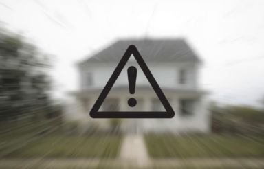 Minimal warning style visual with subtle caution symbol over blurred image of a home.