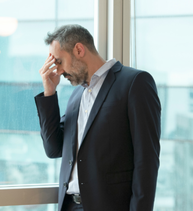 Business owner reviewing commercial insurance documents in office
